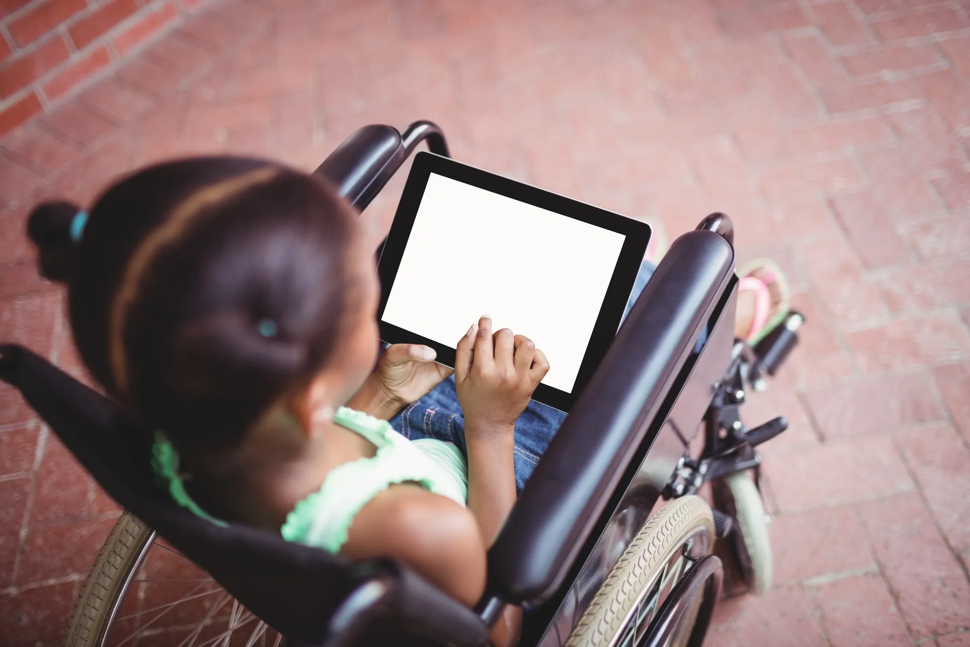 Top view of a girl siting in a wheelchair